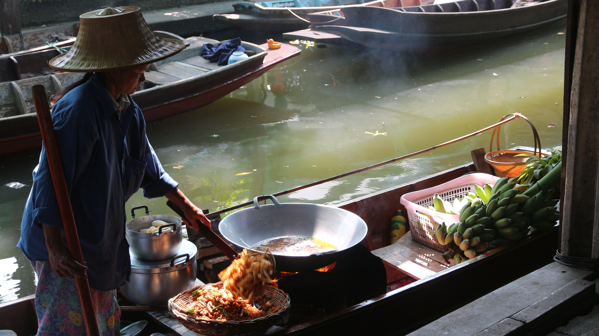 femme thaïlandaise cuisine sur une barque
