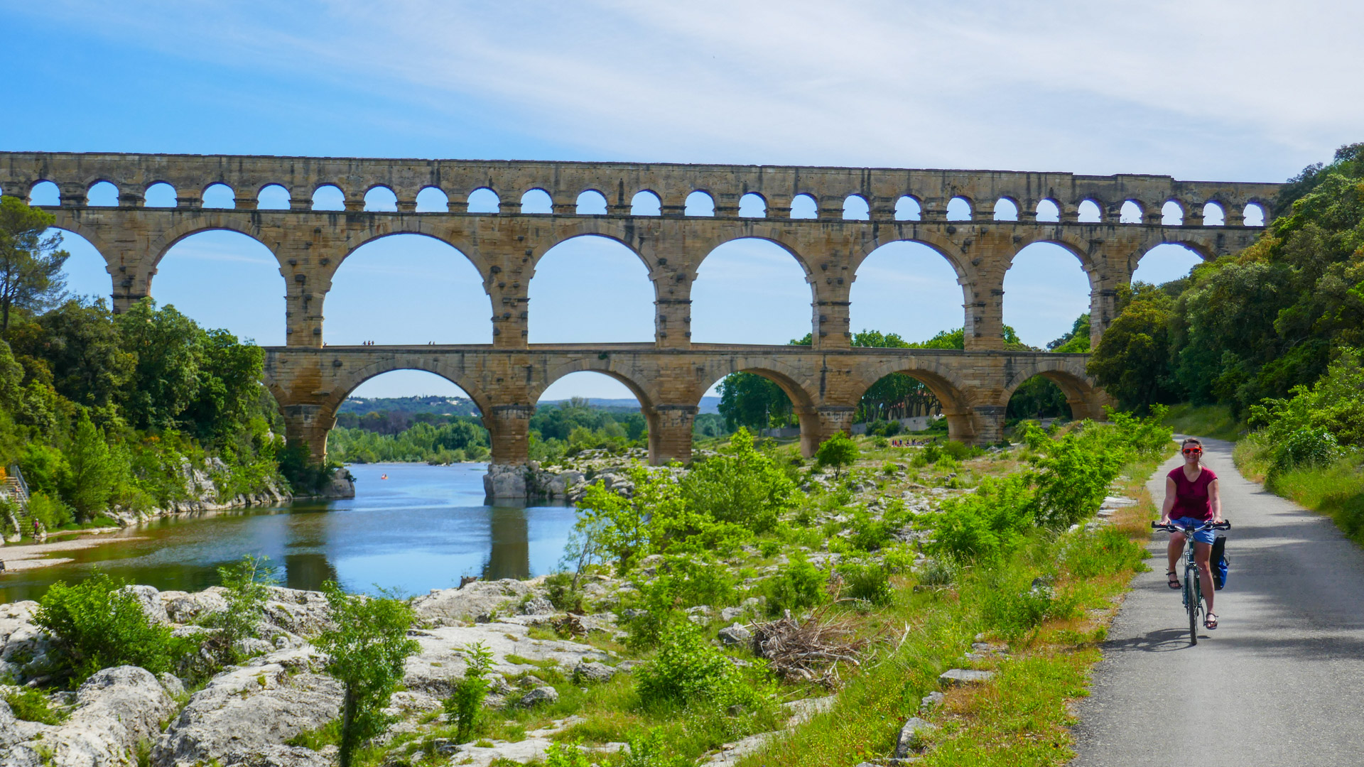 une cycliste devant le pont du Gard