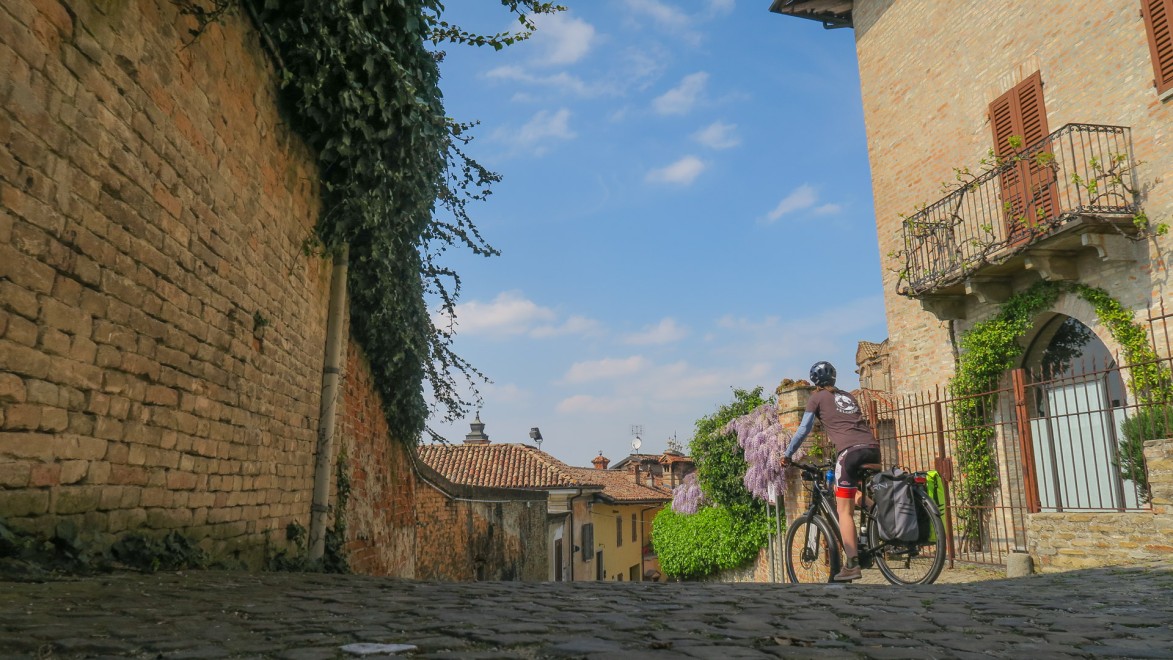 cycliste qui traverse un petit village du Barolo en italie