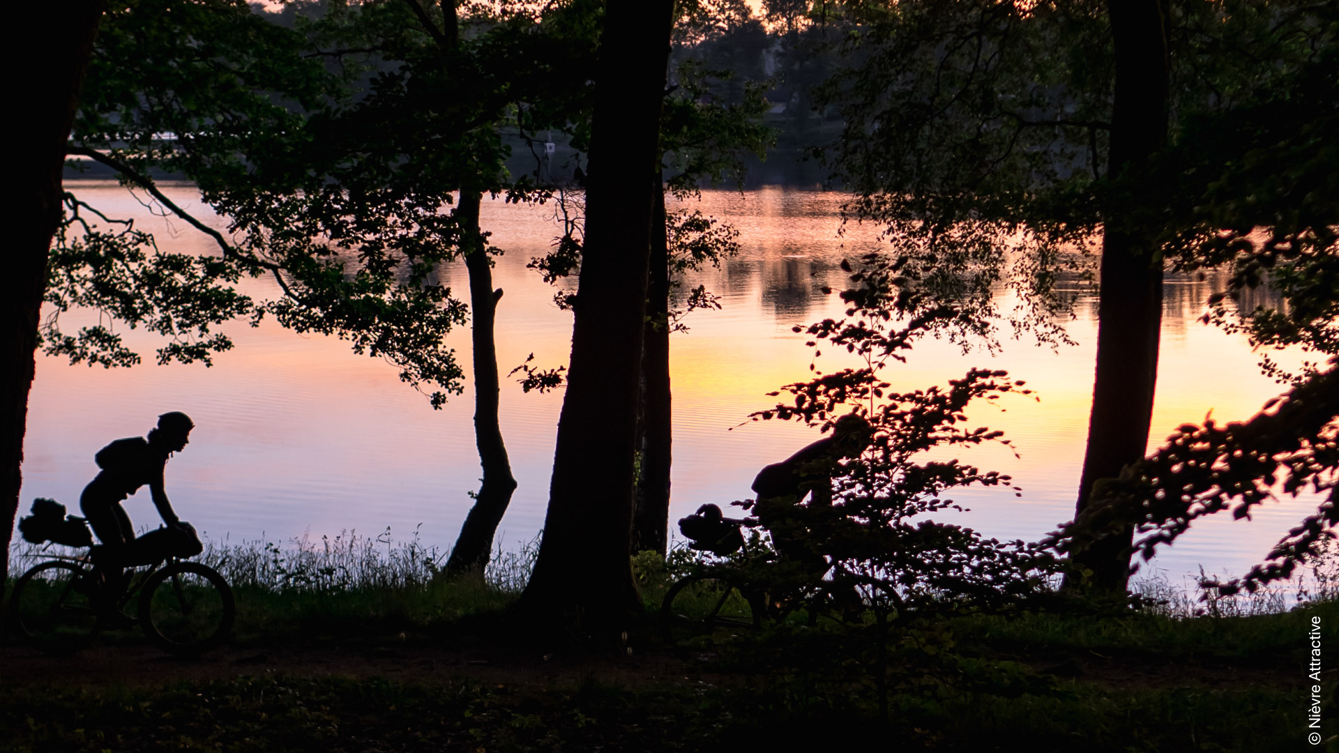 cycliste gravel au bord du Lac des Settons au coucher du soleil