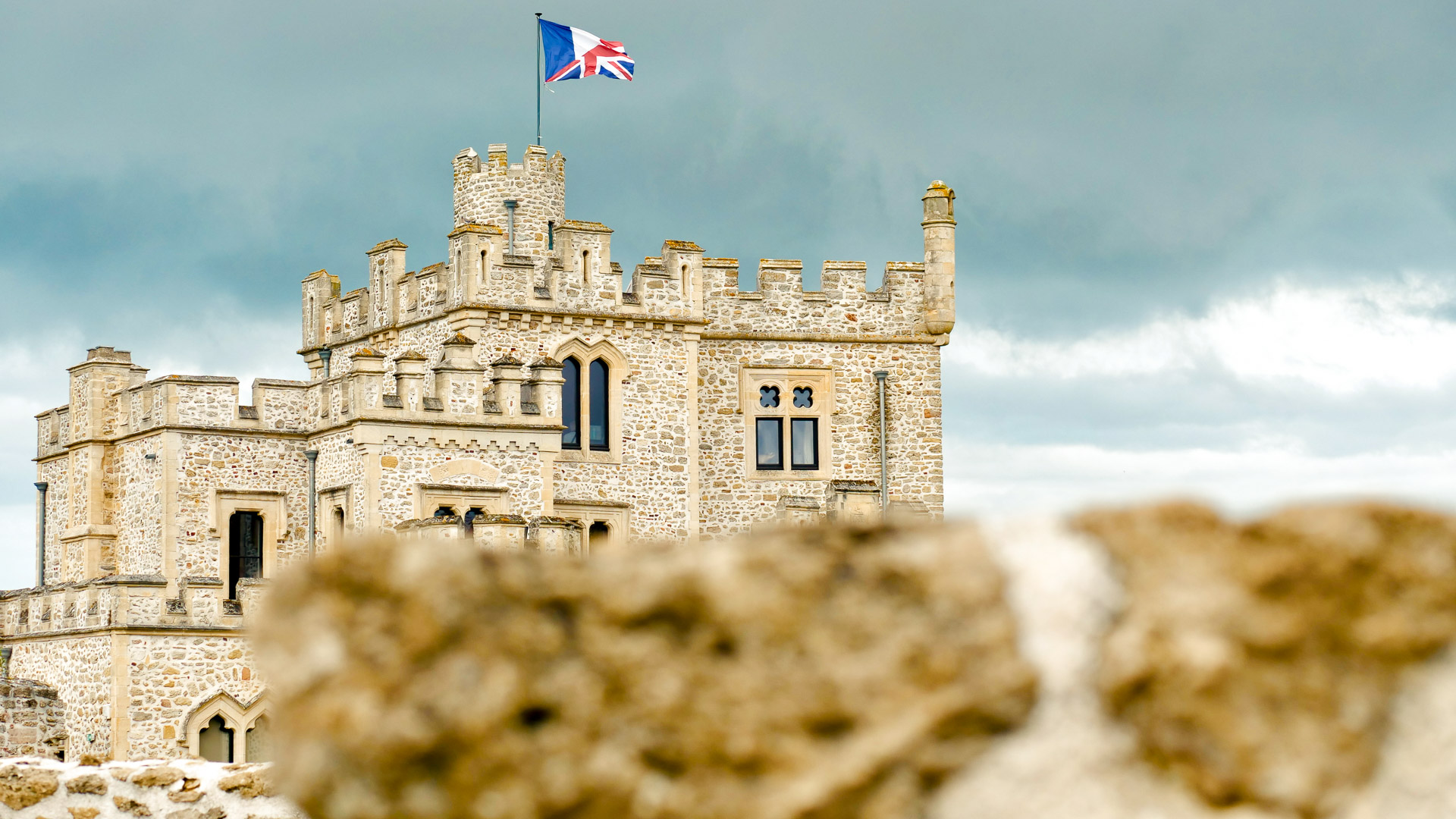 le château d'hardelot, avec son drapeau français flottant au vent, et un ciel nuageux en arrière plan