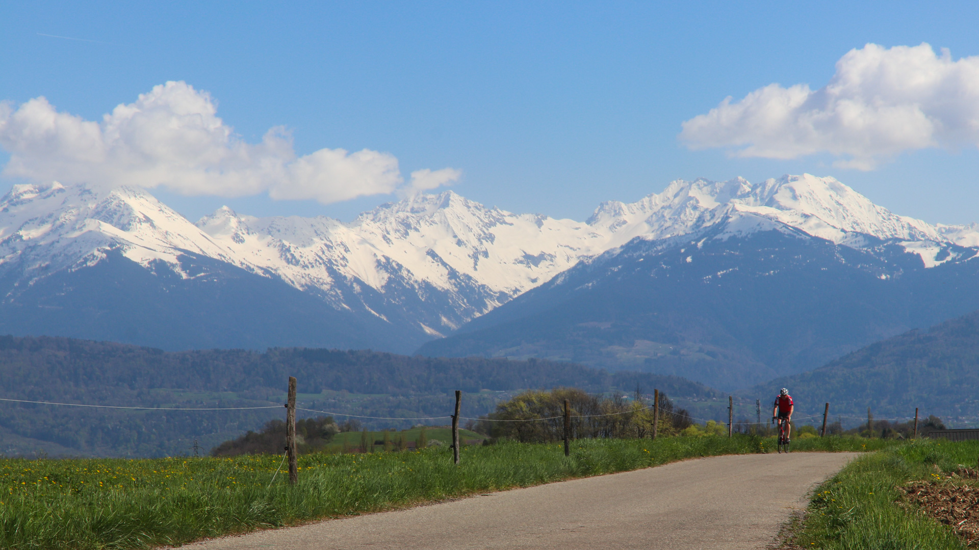 cycliste sur la piste cyclable de Challes-les-eaux, Belledonne enneigé en arrière-plan